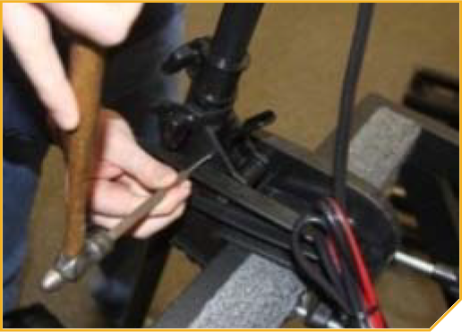 T-Bar_Replacement-_Start_of_removing_the_Tilt_Lever_pin.png